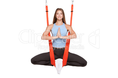 Young woman doing anti-gravity aerial yoga