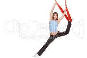 Young woman making antigravity yoga exercises in stretching twine