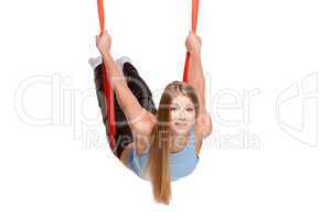 Young woman doing anti-gravity aerial yoga