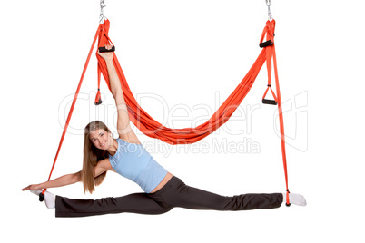 Young woman making antigravity yoga exercises in stretching twine