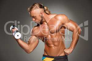 Attractive male body builder on gray background