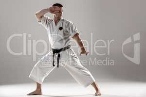 Man in white kimono training karate