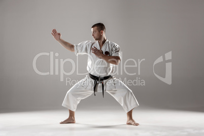 Man in white kimono training karate