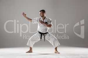 Man in white kimono training karate