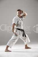 Man in white kimono training karate