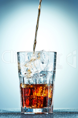 Cola pouring in a glass