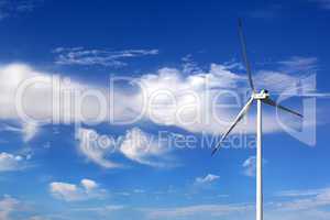 Wind turbine and blue sky with clouds
