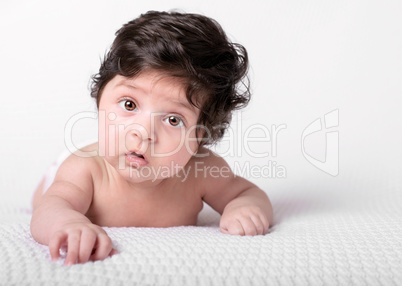 baby with dark shaggy hair