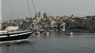The cruise Luzzu boat swimms by and  yacht marina, Birgu, Malta