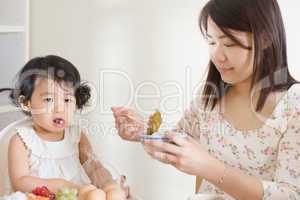 Mother feeding child