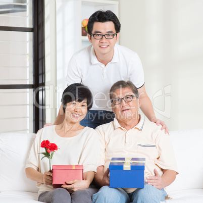 Senior parents receiving gift from child