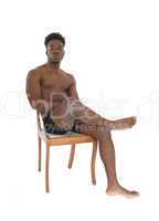 African man sitting on chair.
