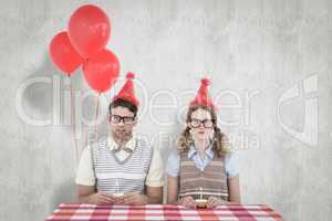 Composite image of geeky hipster couple celebrating his birthday