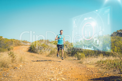 Composite image of athletic man jogging on country trail