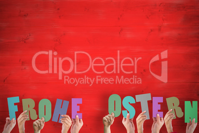 Composite image of hands holding up frohe ostern Composite image of hands holding up frohe ostern