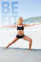 Composite image of fit blonde in warrior pose on the beach