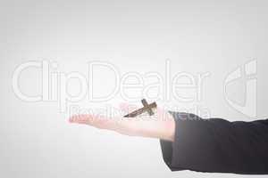 Composite image of businessman holding hand out in presentation