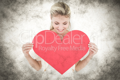 Composite image of attractive young blonde showing red heart