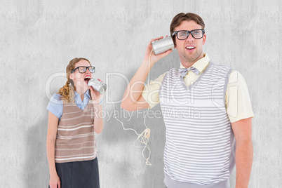 Composite image of geeky hipster couple speaking with tin can ph