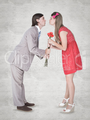 Composite image of cute geeky couple kissing