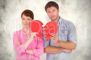 Composite image of couple holding a broken heart