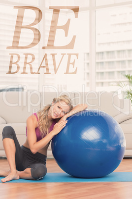 Composite image of fit blonde sitting beside exercise ball smili