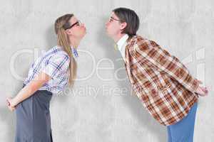 Composite image of geeky hipster couple kissing