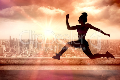 Composite image of fit brunette running and jumping