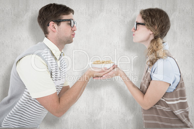 Composite image of geeky hipster couple holding pasta