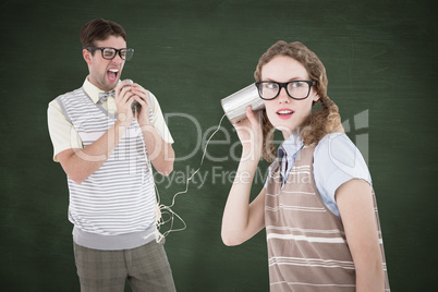 Composite image of geeky hipster couple speaking with tin can ph