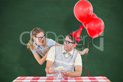 Composite image of geeky hipster couple celebrating his birthday