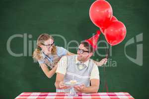 Composite image of geeky hipster couple celebrating his birthday