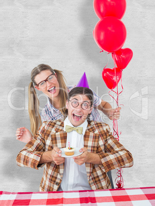 Composite image of geeky hipsters celebrating birthday
