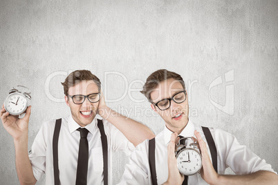 Composite image of nerdy businessman with alarm clock