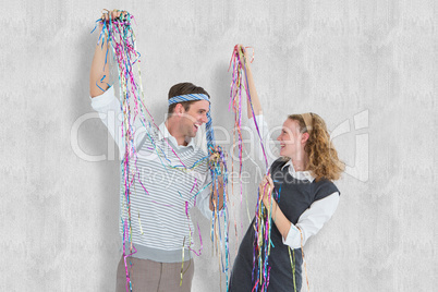 Composite image of happy geeky couple dancing