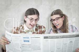 Composite image of geeky hipsters reading the newspaper