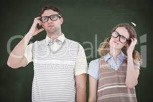 Composite image of geeky hipster couple thinking with hand on te