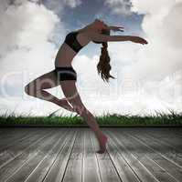 Composite image of side view of a sporty young woman stretching