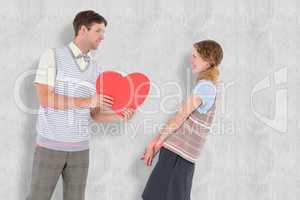 Composite image of geeky hipster giving heart card to his girlfr