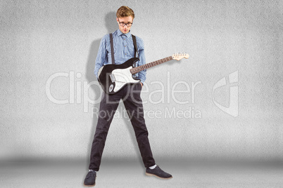 Composite image of geeky hipster playing the guitar