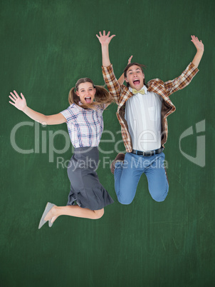 Composite image of geeky hipsters jumping and smiling