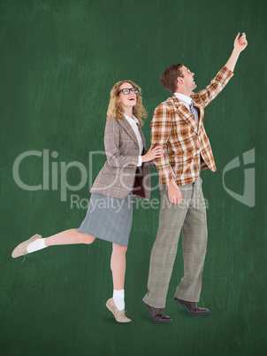 Composite image of happy geeky hipster couple holding their hand