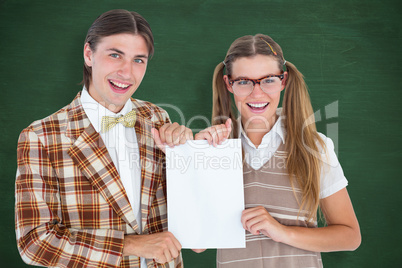Composite image of geeky hipsters holding a poster