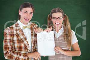 Composite image of geeky hipsters holding a poster