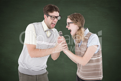 Composite image of geeky hipster couple singing into a microphon