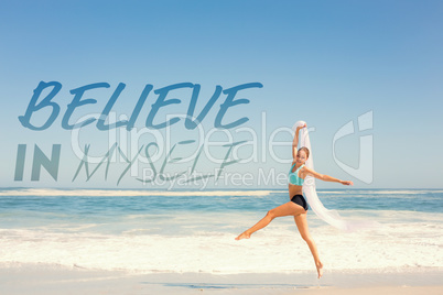 Composite image of fit woman jumping gracefully on the beach wit