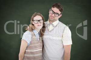 Composite image of happy geeky hipster couple with silly faces