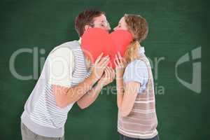 Composite image of geeky hipster couple kissing behind heart car