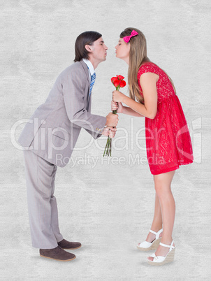 Composite image of cute geeky couple kissing