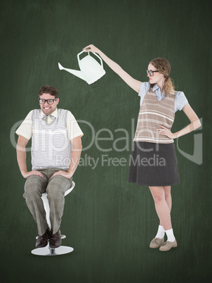 Composite image of geeky hipster holding watering can above her